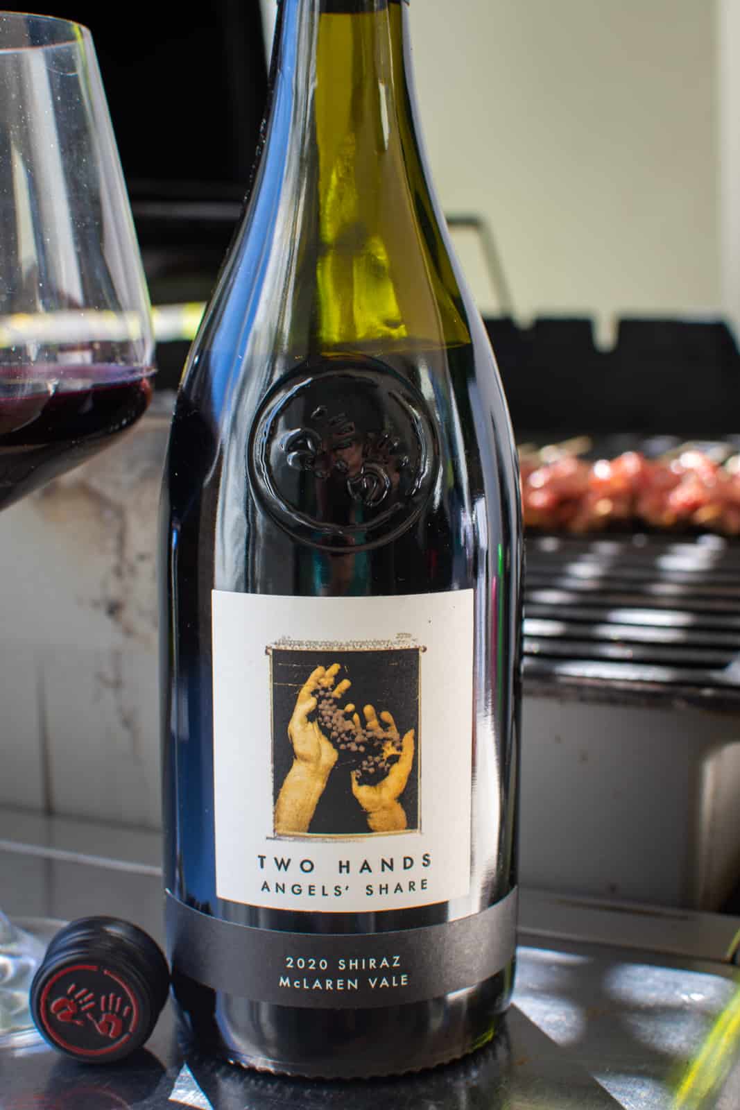 Two hands angels share red wine