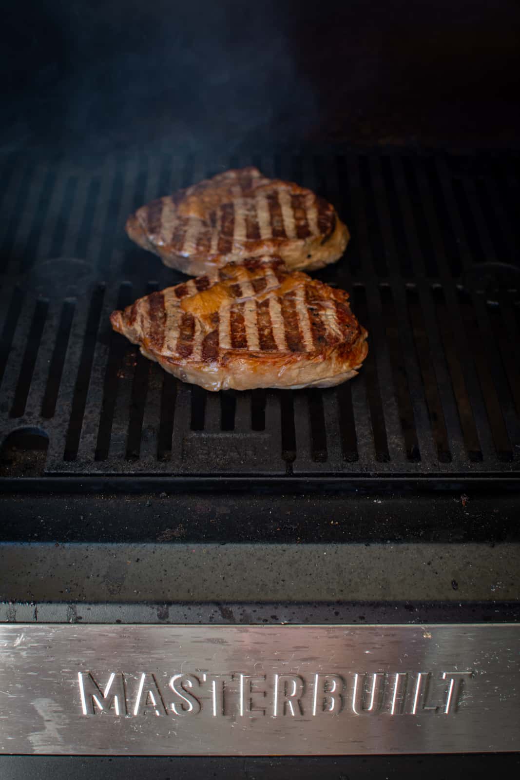 steaks being grilled on masterbuilt BBQ