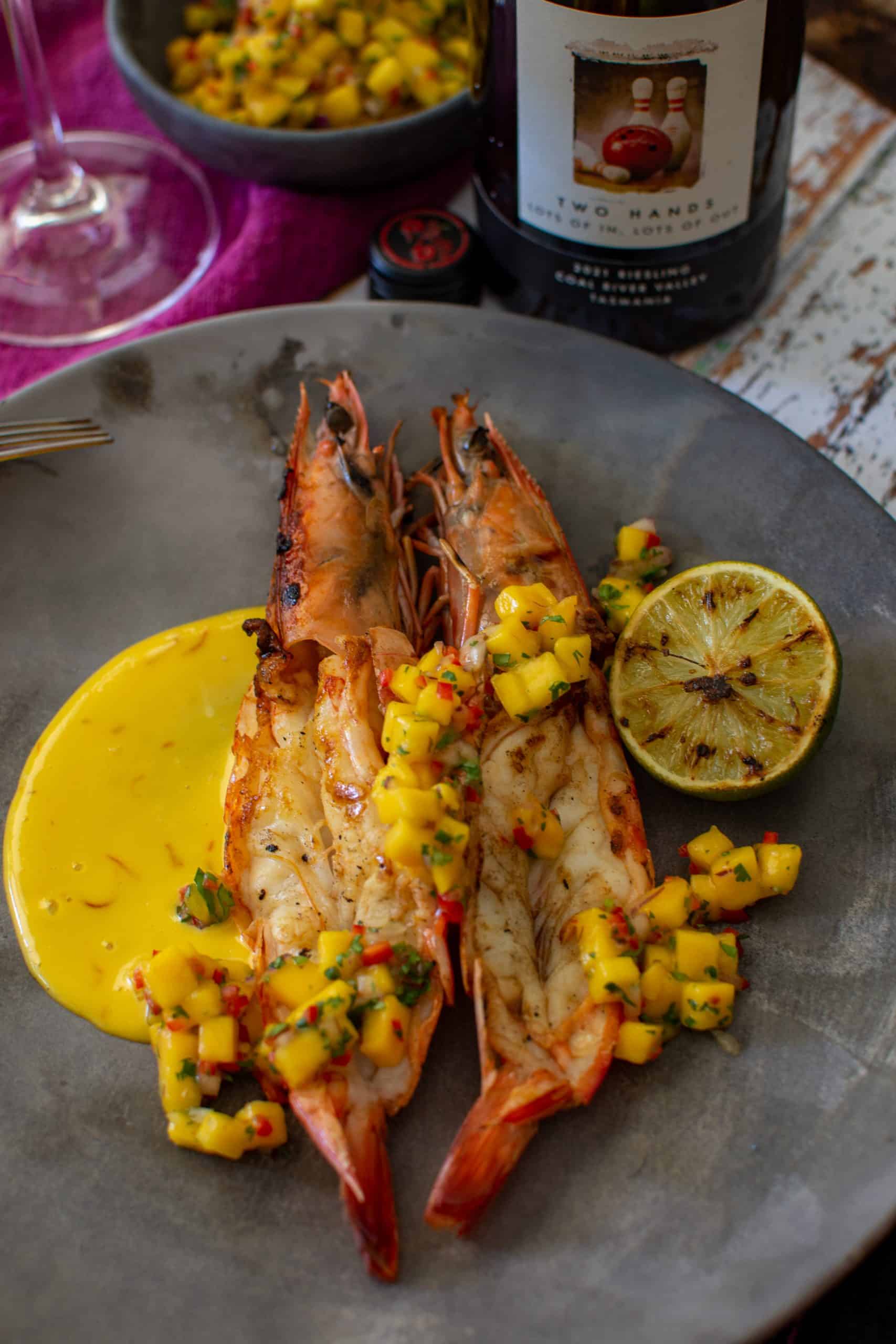 BBQ prawns in a wooden board with saffron aioli and mango chilli salsa