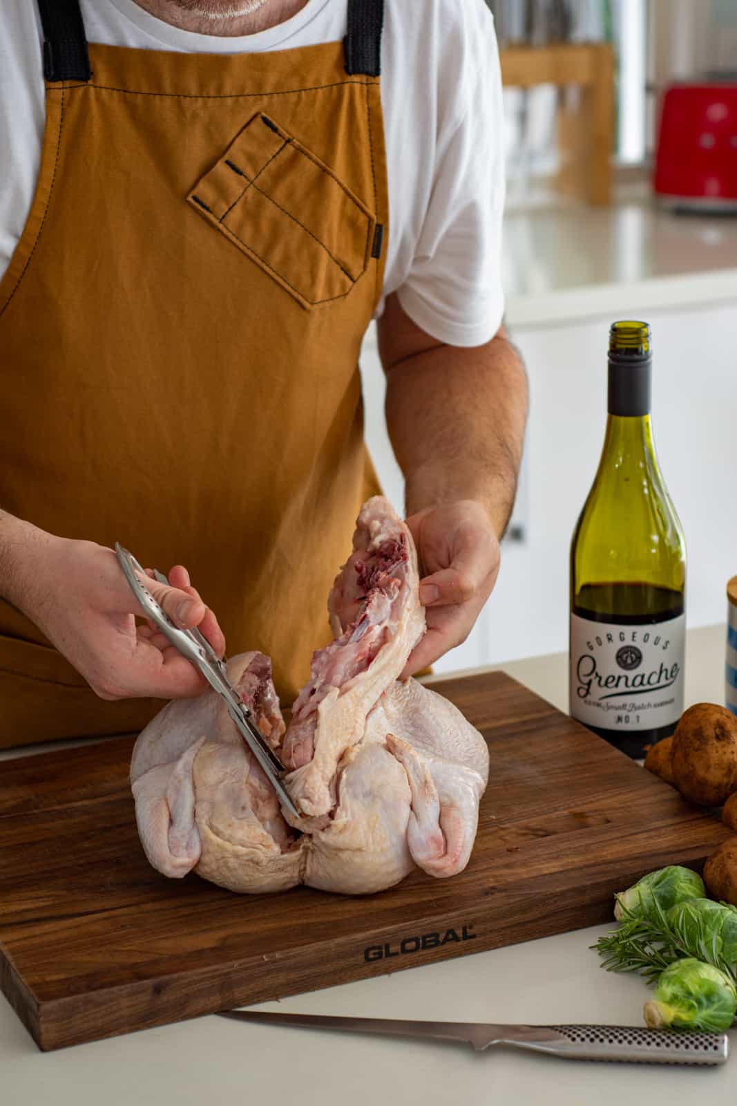 someone spatchcocking a chicken