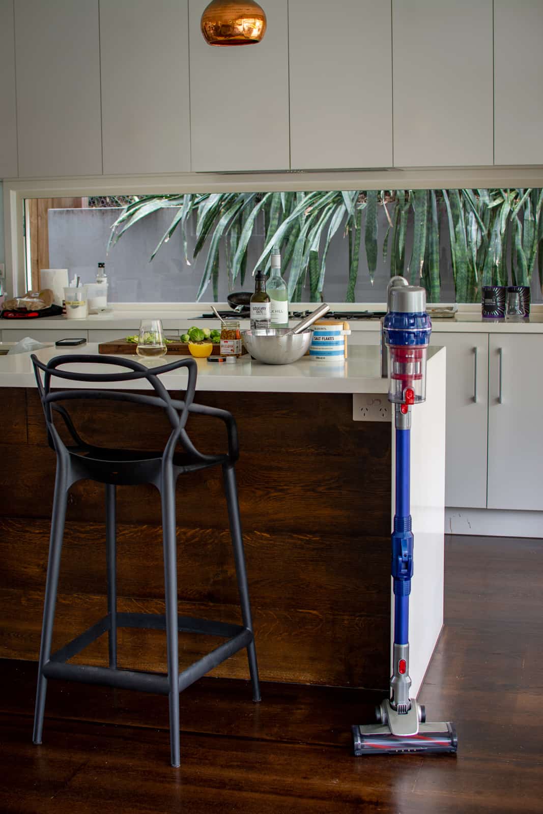 kithen counter top with food on it and vacuum resting against the side