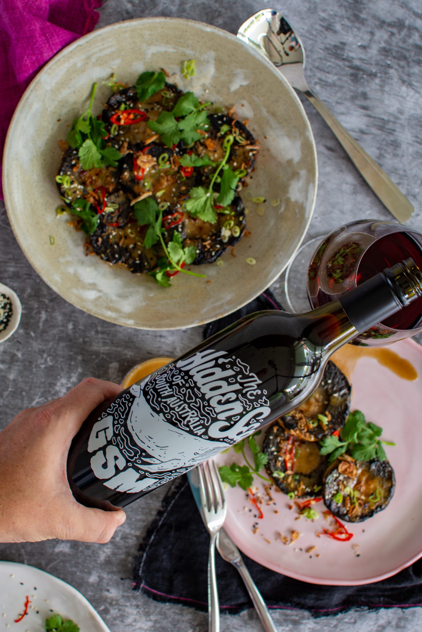 Someone pouring hidden sea GSM with plates of miso mushrooms below