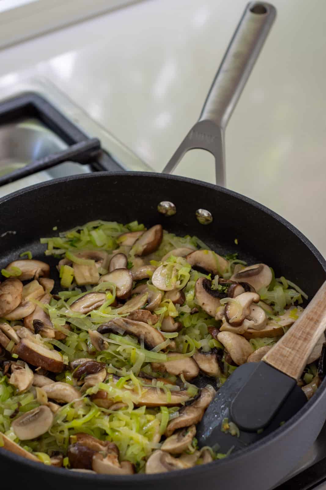 mushrooms, onions & leeks in a frying pan