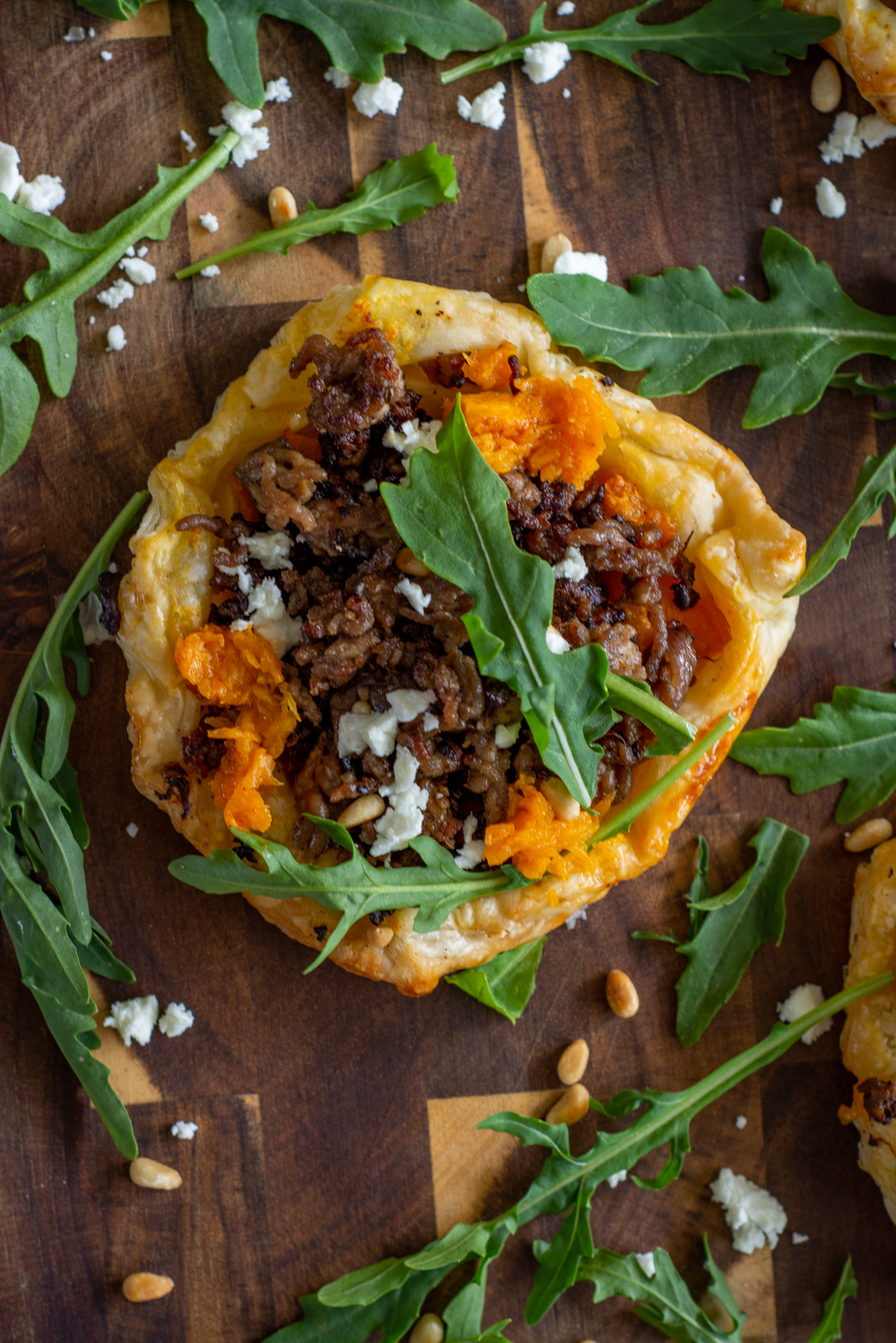Birds eye view of a savoury lamb mince tart on a chopping board