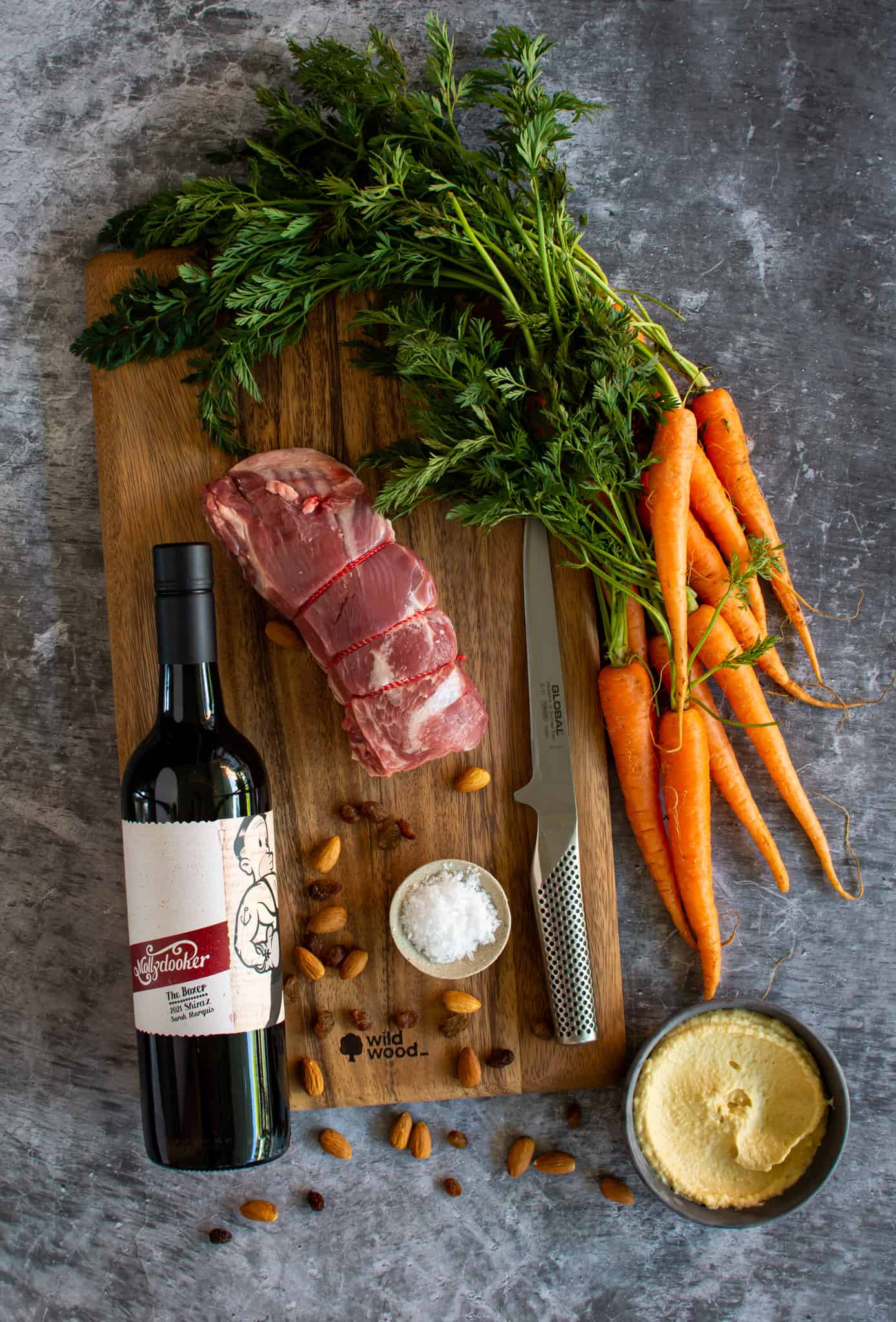 ingredients on a chopping board with a bottle of Mollydooker shiraz next to them