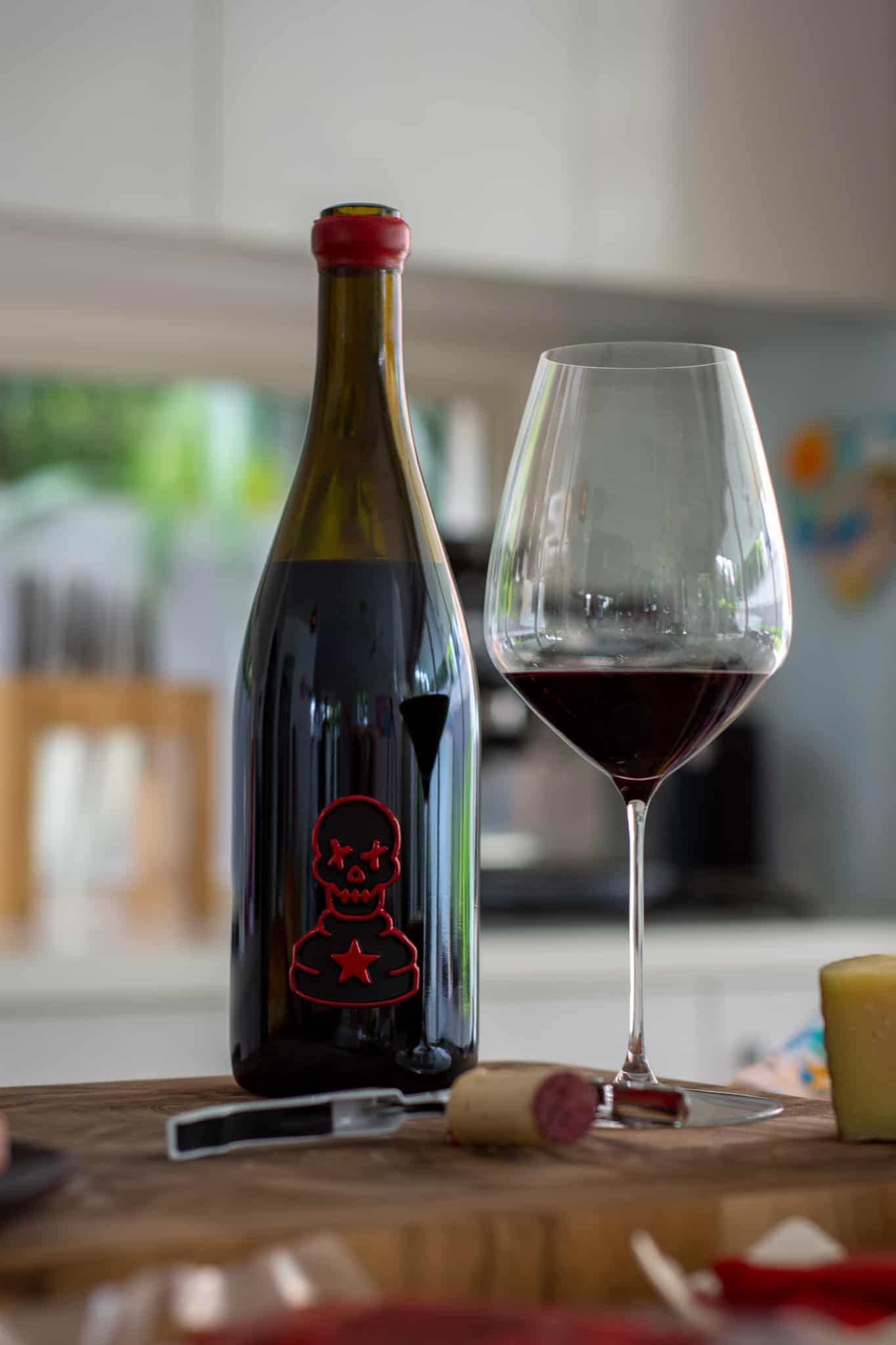 Pawn Wine Co Maturana Tinta wine on a chopping board with a glass of wine and bottle opener beside