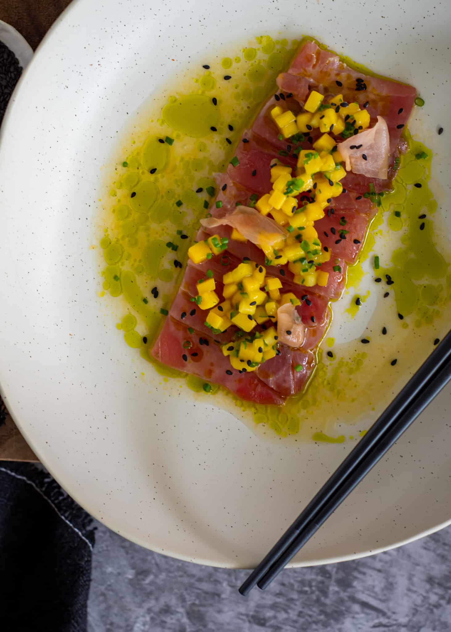 close up of tuna crudo and mango salsa from a birds eye view