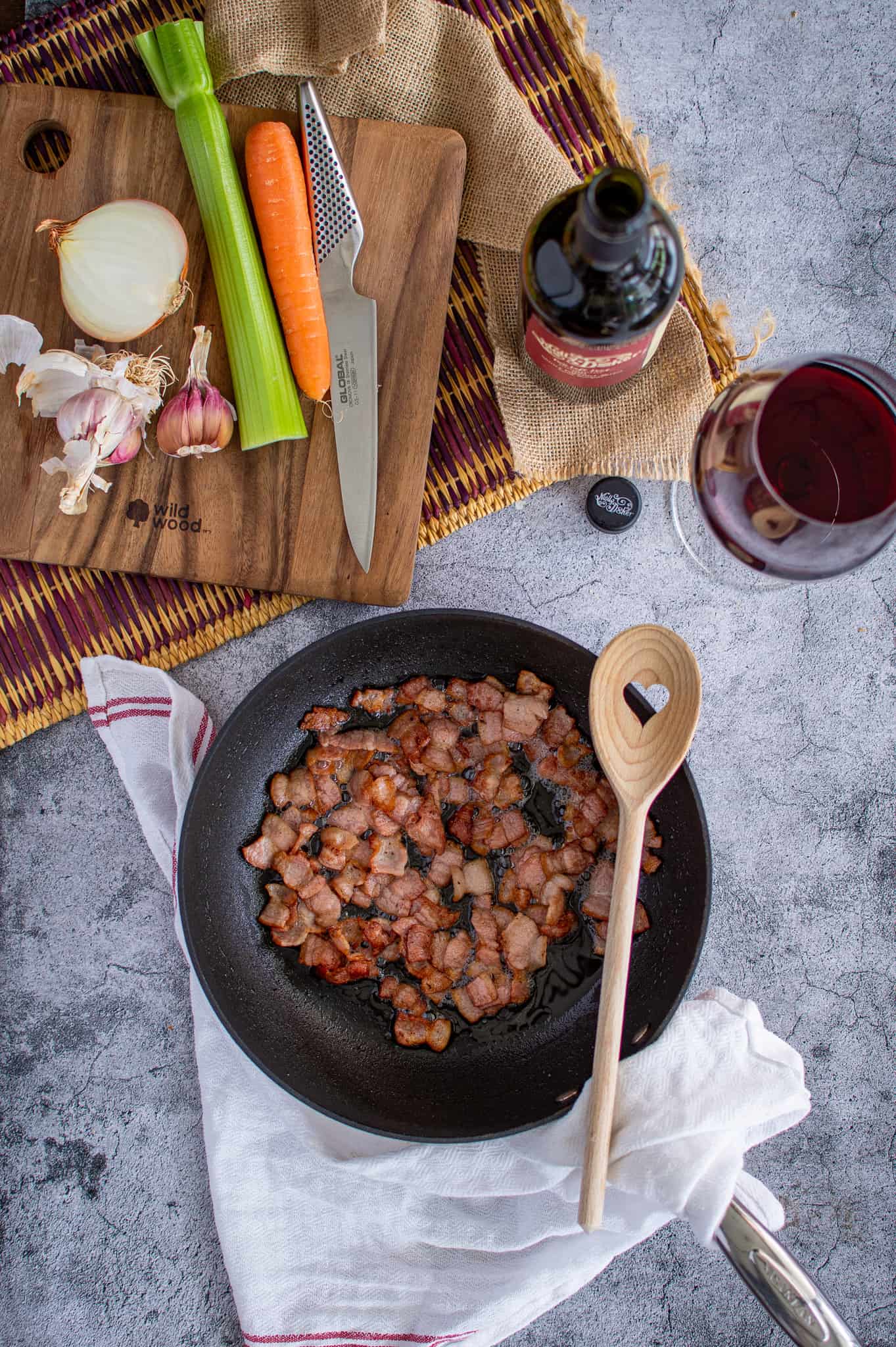 birdseye view of bacon being cooked in a saucepan