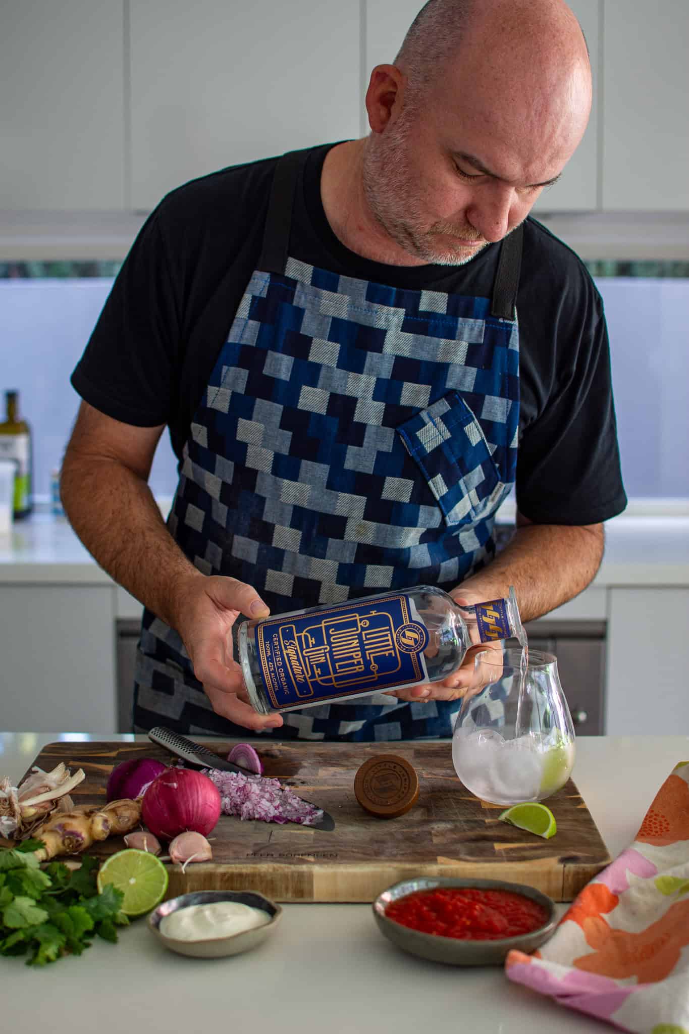 pouring a gin & tonic in the kitchen